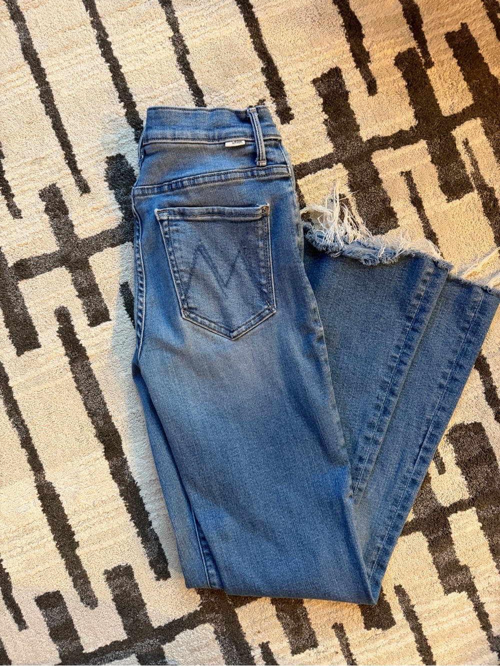 MOTHER High-Rise Flare Jeans in Medium Blue with Distressed Hem
